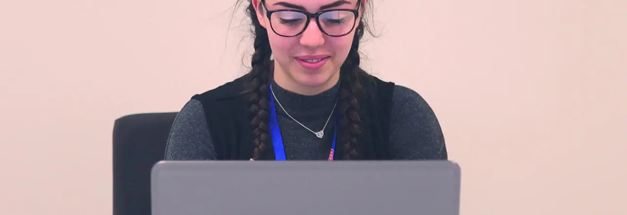 Person sat in front of a laptop.