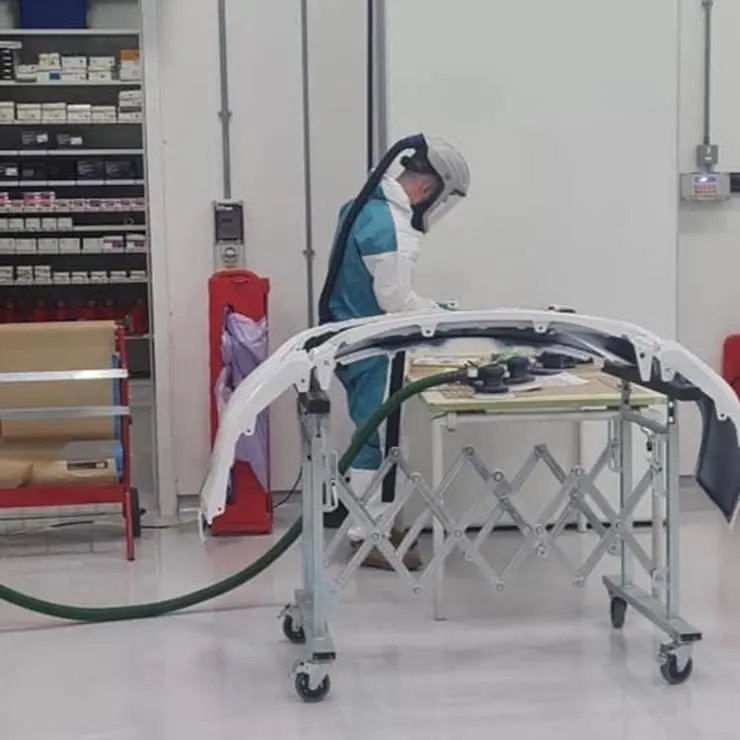 James in the workshop preparing automotive body parts for painting
