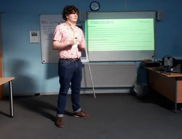 Joseph stood in a classroom environment