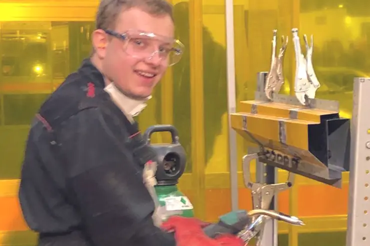 Matthew working at an engineering machine