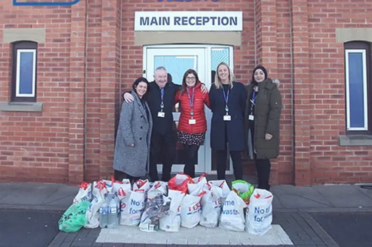 Training 2000 staff stood outside with their donations