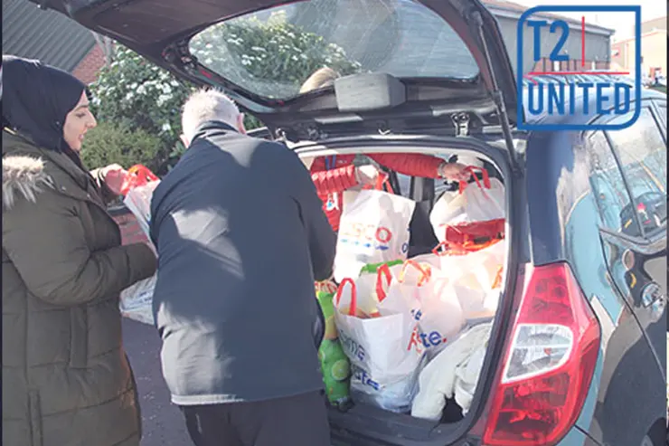 A car being loaded with donations