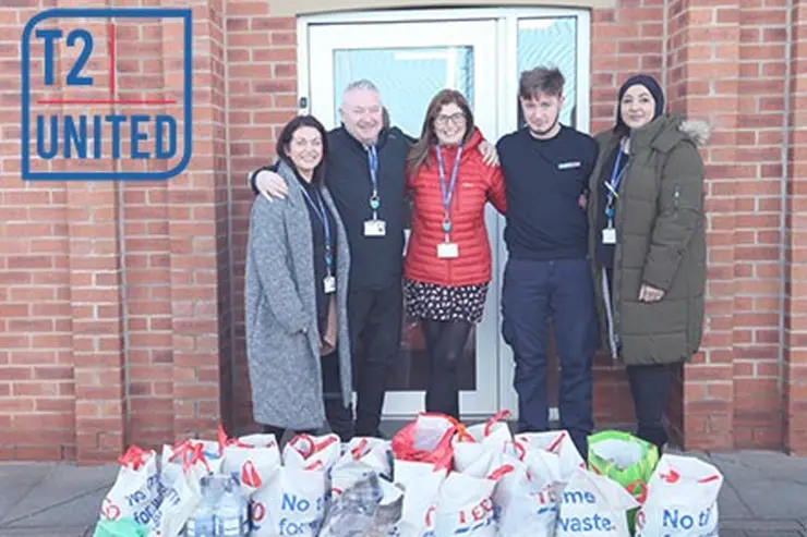 Training 2000 staff stood with their donations