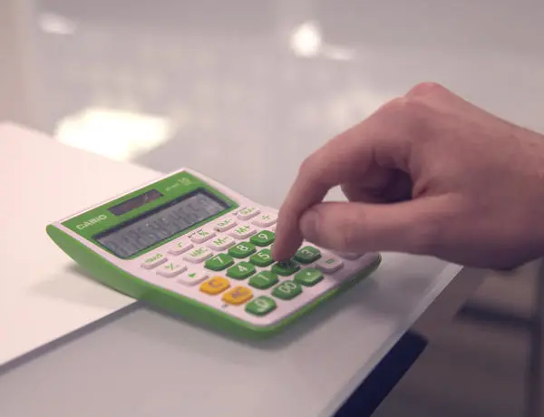 Close up of person using a calculator