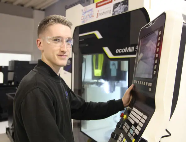 Joseph stood in front of an engineering machine